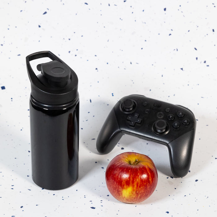 Amore 500ml Junior Bottle - Free Flow Lid - A drink bottle with a free flow lid, presented in sleek black, alongside a gaming controller and a red apple.