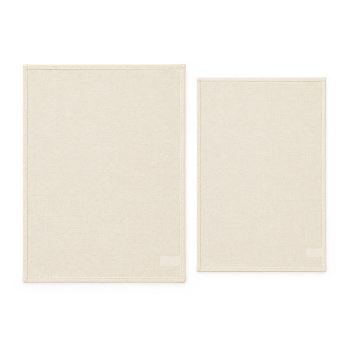 Haven Medium Cotton Tea Towel - Two cotton tea towels in a light beige colour, one larger and one smaller, both featuring a brand logo.