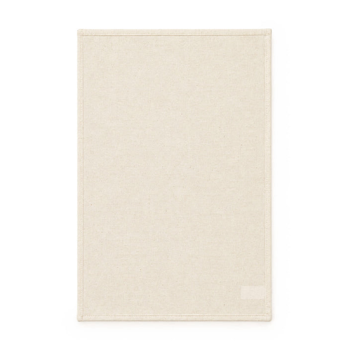 Haven Medium Cotton Tea Towel - A medium cotton tea towel in a light cream colour with a simple border and a logo at the bottom.