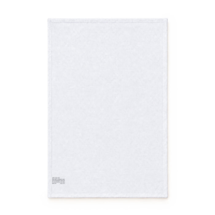 Haven Medium Cotton Tea Towel - A white cotton tea towel featuring a stitched edge and a small logo in the corner.
