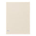 Haven Large Cotton Tea Towel - A large cream cotton tea towel featuring a plain design and a small label in one corner.