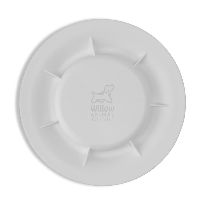 Sip n Fly Pet Bowl - A white pet bowl featuring a logo, with a round design and raised sections around the edge.