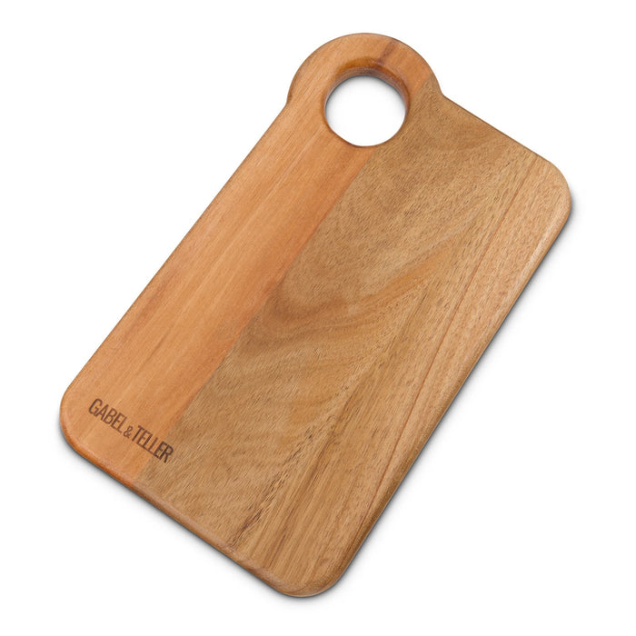 The Nibble Set - A wooden chopping board with a round handle, featuring a natural finish and a subtle brand logo.