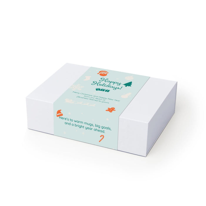 The Warm Welcome - A white gift box featuring a light blue label with holiday-themed illustrations and a festive message.