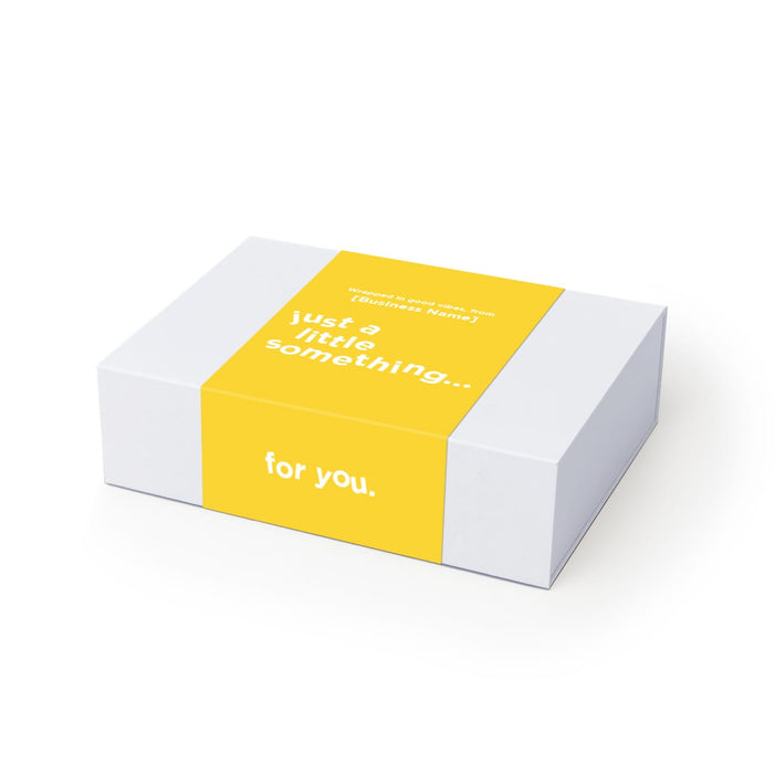 The Brew Ritual - A gift box with a white exterior and a bright yellow band, featuring minimalist text.