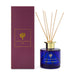 The Host Edit - A blue glass reed diffuser with wooden sticks, presented in a purple box. The product is scented with patchouli and aniseed.