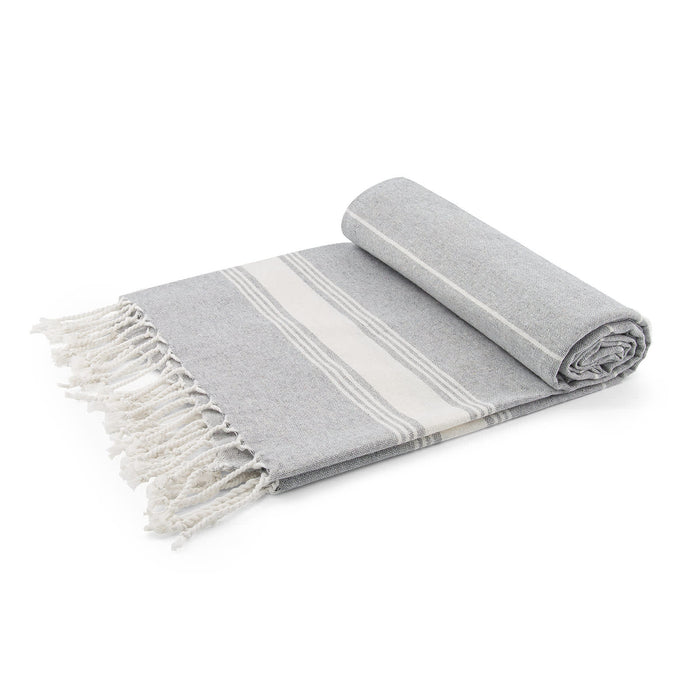 Bubbles & Beachdays - A grey blanket with white stripes and fringed edges, neatly rolled and displayed. It has a simple, elegant design.