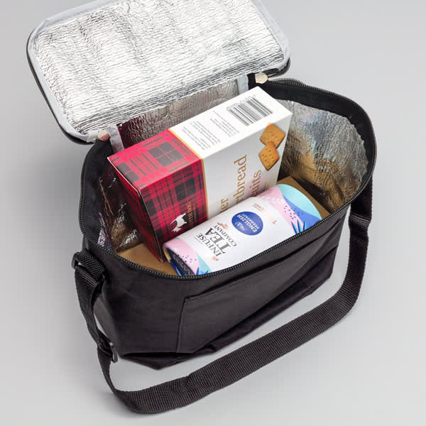 The Brew & Bite - A black cooler bag with a silver insulated interior, holding snacks and a drink carton inside.