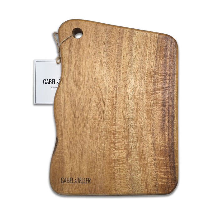 The Refined Graze - A wooden cutting board with a unique shape and a hole for hanging. It has a logo and a tag attached.