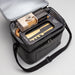 The Chandon Escape - A grey insulated hamper with a wooden cheese board, utensils, and snacks inside, featuring a logo on the exterior.