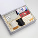 The Brew Ritual - A gift box containing a striped cloth, two coffee mugs (one white with a cork base, one black), and shortbread biscuits.