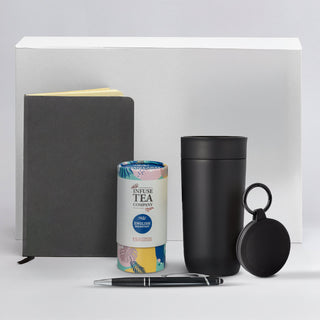 The Ultimate Welcome - Tea Edition - A black drink bottle, a grey notebook, a pen, a tea canister, and a small black accessory with a logo.