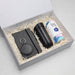 The Ultimate Welcome - Tea Edition - A gift box contains a black drink bottle, a notebook, a keyring, and a canister of tea, all nestled in shredded paper.