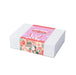 The Sweet Setup - A gift box with a pastel pink design featuring bunny illustrations and decorative patterns, secured with a printed band.