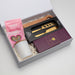 The Generous Host - A gift box containing a knife set, a wooden utensil, a candle, and pink chocolate-covered frogs.