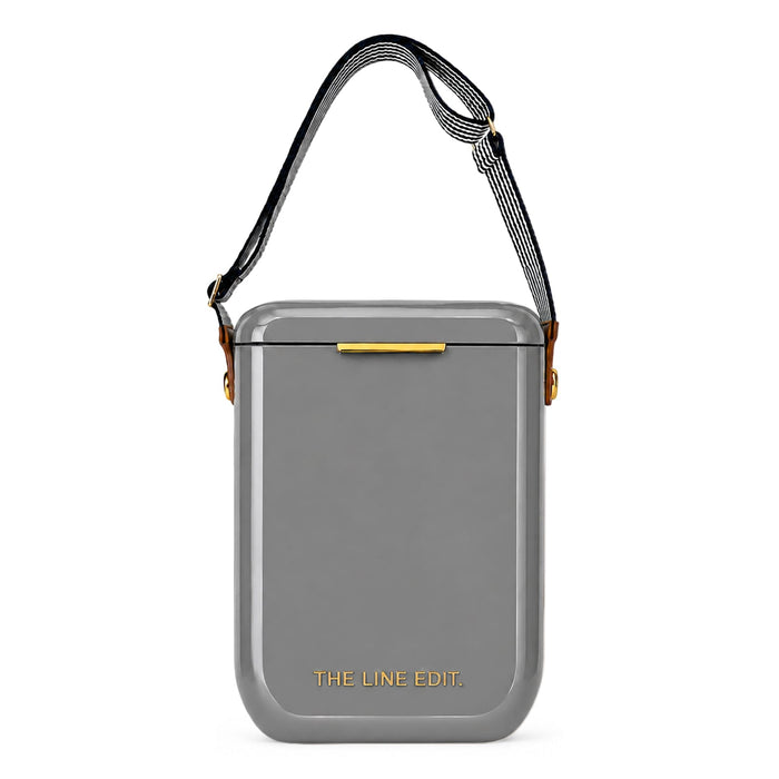 The Festive Edit Gift Set - A grey cooler with a shoulder strap and a logo on the front, featuring a sleek, modern design.