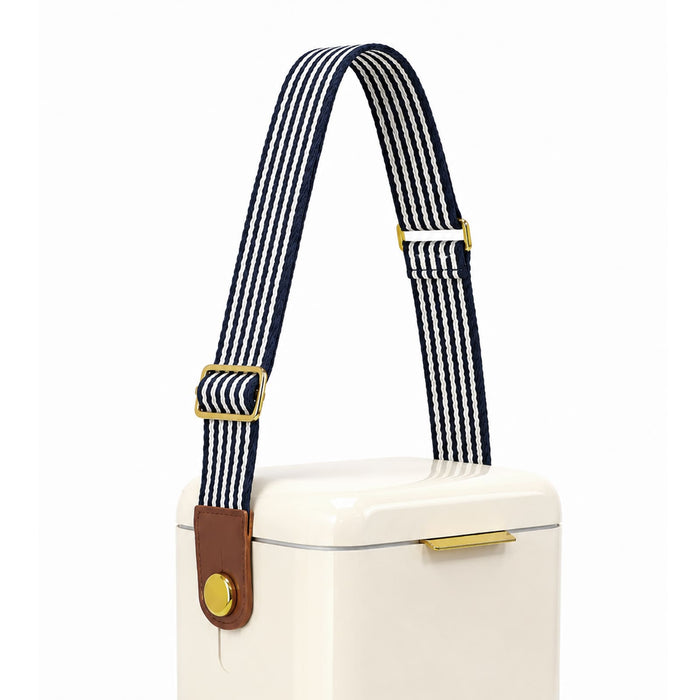 Pavilion Cooler by The Line Edit. - A cooler with a cream body features a navy and white striped shoulder strap and a brown leather accent.