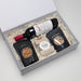 The Perfect Pairing - A drink bottle, a bottle of red wine, pretzels, salted nuts, and caramel fudge in a gift box.