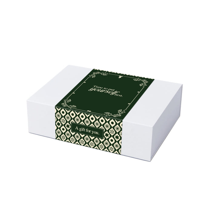 The Modern Essential Gift Set - A white hamper box with a green decorative band featuring intricate patterns and a gift message.