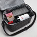 The Wine & Unwind - A drink bottle bag in grey containing a bottle of red wine and two other boxed items, with a silver interior.