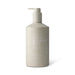 The Pamper & Entertain Edit - A cream bottle in a neutral beige shade with a pump dispenser, featuring a logo and "Great Barrier Reef" branding.