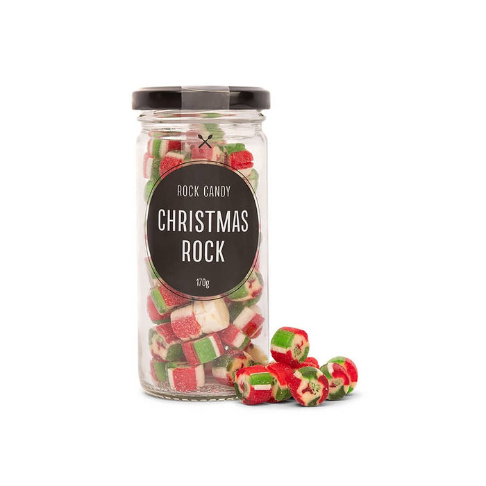 The Festive Edit Gift Set - A glass jar filled with red, green, and white rock candy pieces, with some scattered outside. The jar has a black lid.