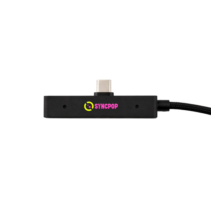 Tech Pack Charge - A black rectangular charging hub with a USB-C connector and a textured cable, featuring a colourful logo.