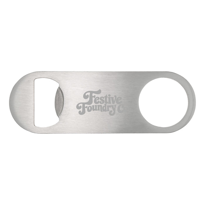 The Knock Off for Christmas Pack - A silver bottle opener with a circular cutout and an engraved logo. Simple and sleek design.