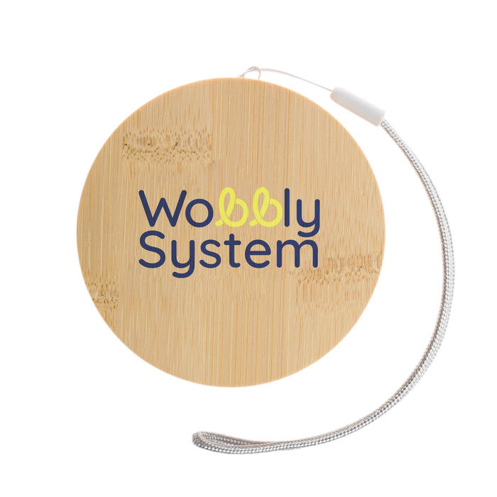 The Good Stuff Pack - A round bamboo coaster with a silver string, featuring a logo in blue and yellow.