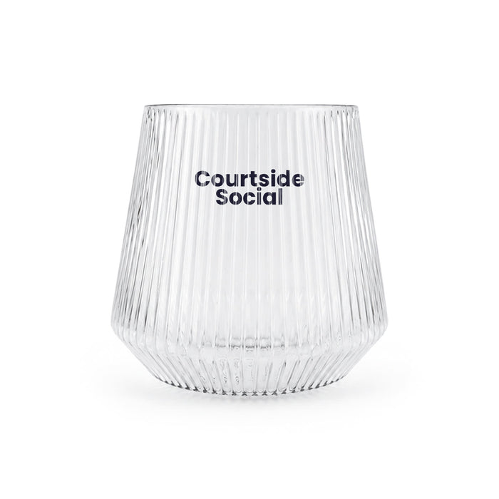 The Play & Graze - A clear, ribbed glass featuring the branding "Courtside Social." The glass has a tapered shape.