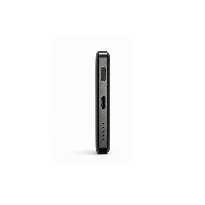 Axial by Nomis Solid State Power Bank - A sleek black solid state power bank with a slim profile and ports on one side, featuring a branding logo.