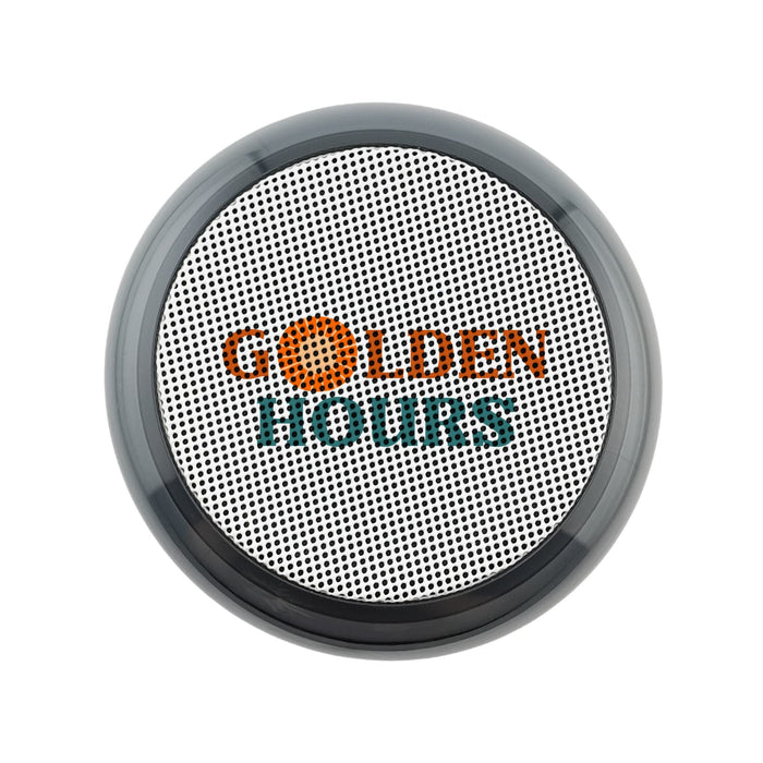 Dazzle RGB Speaker - A round, black and silver speaker with a textured surface and a logo on the front.