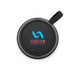 Empire Maglock Ph Stand Speaker - A circular black speaker with a textured surface and a strap, featuring a logo in blue and pink.
