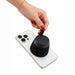 Empire Maglock Ph Stand Speaker - A black portable speaker being attached to a smartphone, showcasing a sleek design and convenient size.