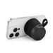 Empire Maglock Ph Stand Speaker - A black, cylindrical speaker with a textured surface, positioned against a smartphone. The speaker has a carrying strap.