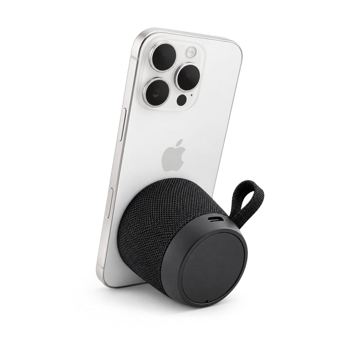 Empire Maglock Ph Stand Speaker - A black speaker connected to a smartphone, featuring a textured fabric exterior and a loop for attachment.