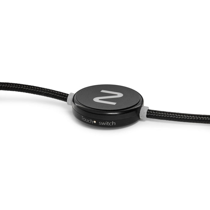The Modern Essential Gift Set - A black charging cable with a round switch feature and a textured exterior. It includes a logo on the switch.