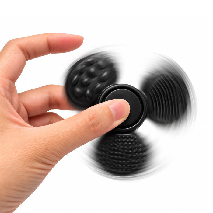 Tactile Fidget Spinner - A black tactile fidget spinner is being spun between fingers, featuring different textured surfaces.