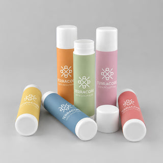 Flavoured Lip Balm SPF - A collection of flavoured lip balms in pastel shades of pink, green, orange, yellow, and white, featuring a logo.