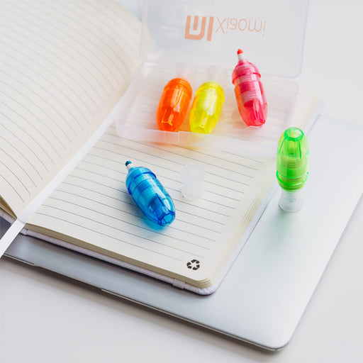 Mackie Highlighter Sets - Mackie highlighter set featuring vibrant blue, green, yellow, and orange highlighters in a clear case on a notebook.