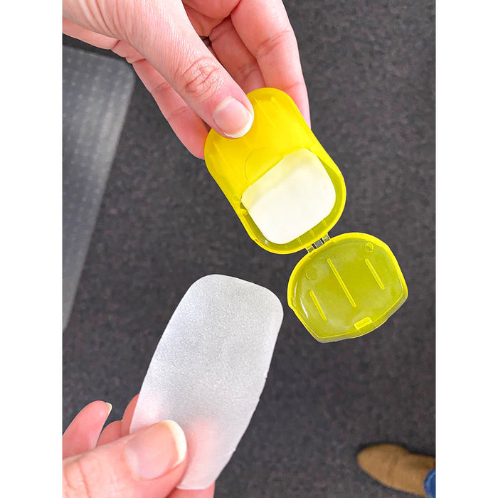 Soapy - A yellow product container held in a hand, revealing a transparent, flexible pad inside.