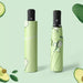 Full Colour Poppins Umbrella - A green umbrella featuring an avocado design, neatly folded and compact. It includes a handle and has branding.