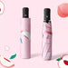 Full Colour Poppins Umbrella - A pink umbrella with a peach design, featuring a compact case and a black handle. It has a logo.