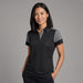 Women's Printer Prime Polo - A woman models a women's polo shirt in black with grey accents, featuring a collar and short sleeves.
