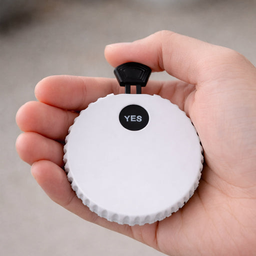 Yes or No Game Set Bottle Opener - A drink bottle opener in white with a black toggle on top, held in a person's hand. Features a logo.