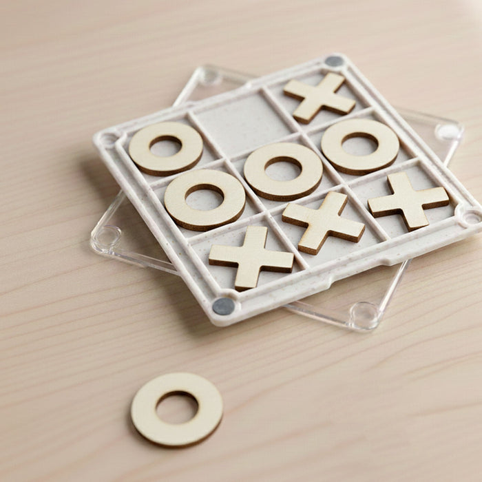 Tic Tac Toe Board Game Coaster - A Tic Tac Toe board game coaster with a clear base, featuring wooden X and O pieces in a grid pattern.