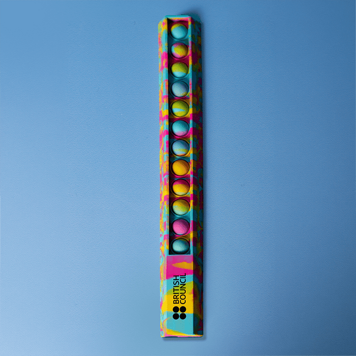 30cm Popper Ruler - A 30cm popper ruler featuring a vibrant design with blue and multicoloured dots, alongside a logo.