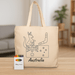 Squiggle Calico bag + Crayon set - A beige tote bag featuring an illustration of a kangaroo and Australian symbols, accompanied by a crayon set.