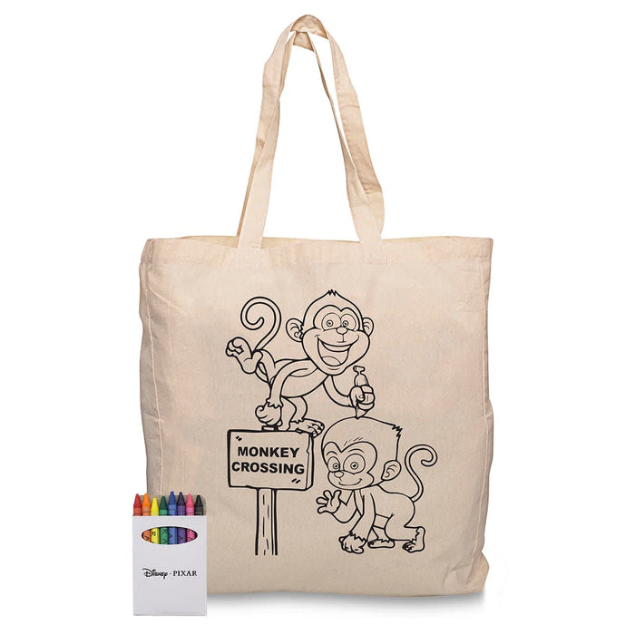 Squiggle Calico bag + Crayon set - A cream-coloured calico bag featuring monkey designs and a set of crayons in various colours beside it.