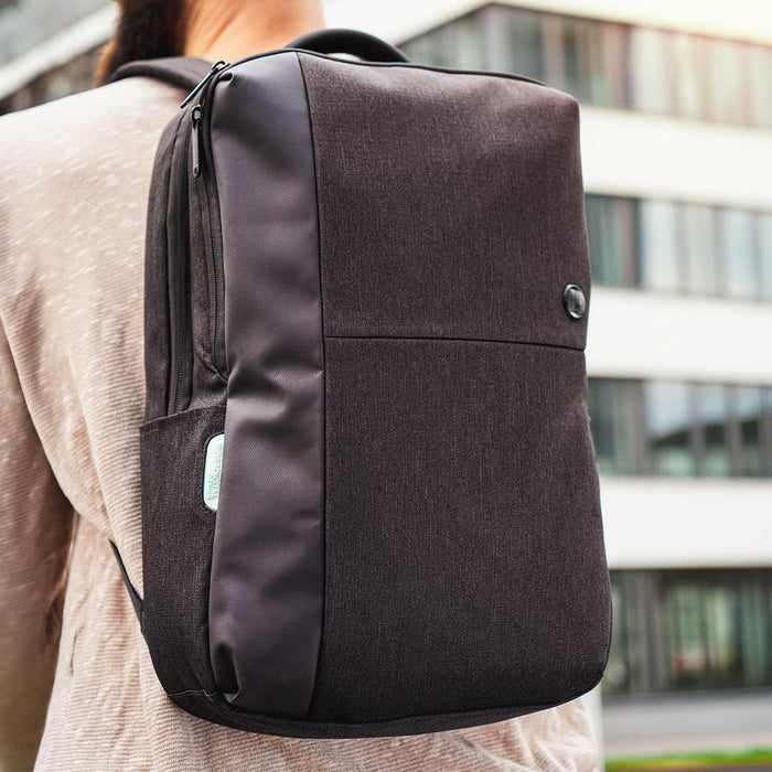 Swissdigital Arosa Backpack - A black Swissdigital Arosa Backpack displayed on a model's back, featuring a sleek design and a logo.